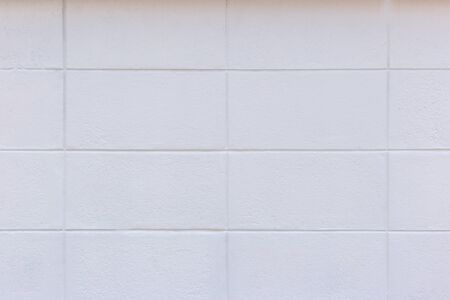 The white square patterned cement wall is an abstract image of the wall surface.の写真素材
