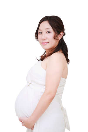 A beautiful smiling pregnant woman on white.の写真素材