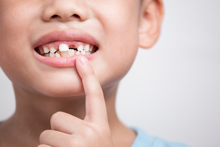 Close up headshot cropped image little preschool cute boy widely smilin showing empty space with growing first permanent molar Happy six years old small losing primary baby teeth 
isolated on a whiteの写真素材