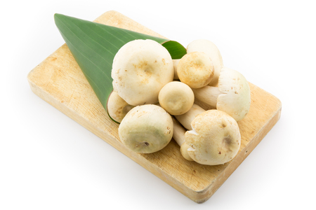 Mushroom wrap with Banana leaf on wood cutting boardの写真素材