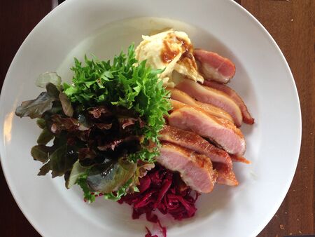 Sliced Grill Pork With Mash Potato and salad in the restaurantの写真素材