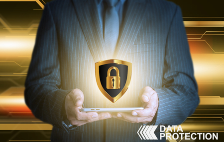 Businessman holding tablet data protection shieldの写真素材