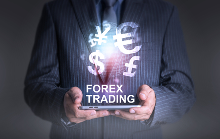 Businessman holding tablet world of currency forex tradingの写真素材