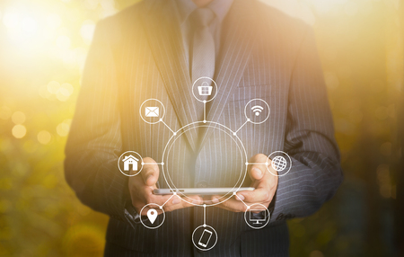 Businessman holding tablet multichannel online communication networkの写真素材
