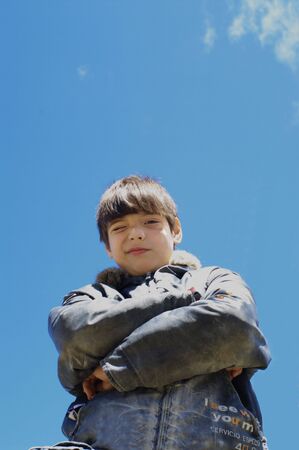 The boy against the dark blue skyの写真素材