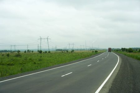 Road in the country against  electricity supportの写真素材
