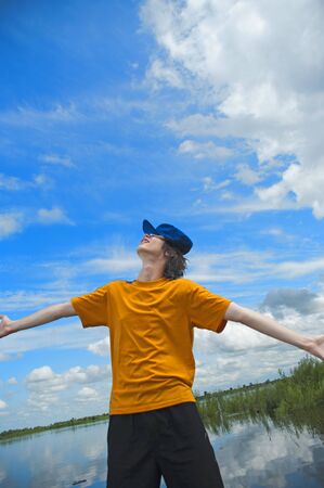 The young man against the sky looking afarの写真素材