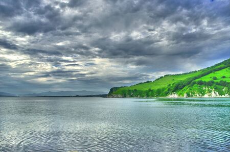 Sea coast before a storm with cloudsの写真素材