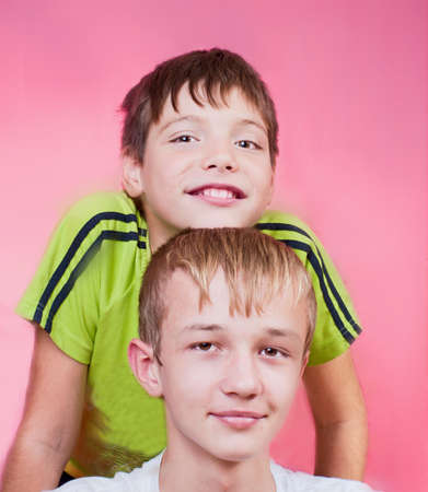  Two teenagers a hill on a pink background in studioの写真素材