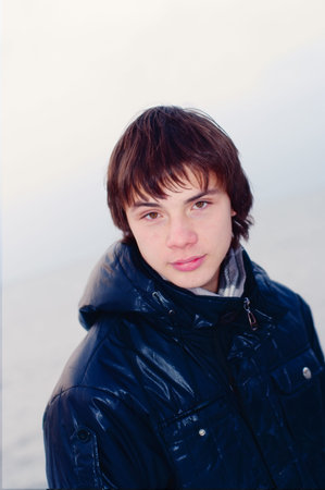 The teenager in a jacket on a white background