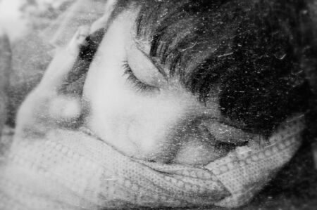 Sleeping Boy with thumb in the mouth on blackの写真素材