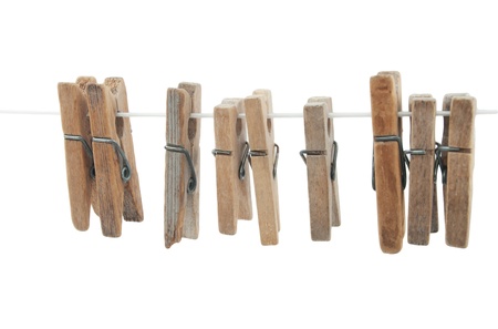  wooden clothespins on rope  on white backgroundの写真素材