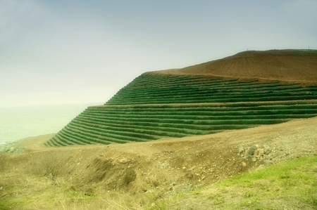 Storehouse of the buried firm household waste, processing in the earth on seacoastの写真素材