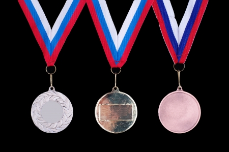 Three medals, Gold, Silver and bronze for the winners on the black backgroundの写真素材