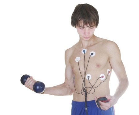 Sexy body of young athletic man with weight and control the heart device, isolated on whiteの写真素材