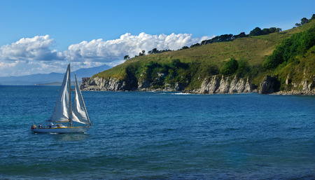 Sailboat sailing in the morning with blue cloudy skyの写真素材