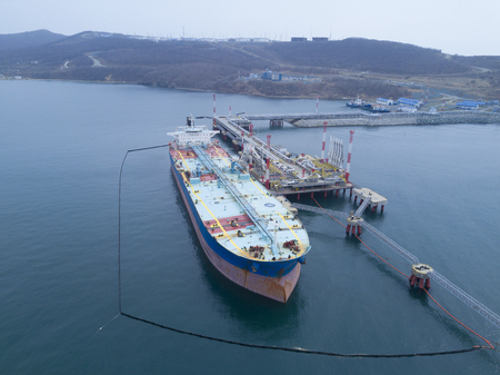 Liquid bulk oil tanker in port Fenced with boomsの写真素材