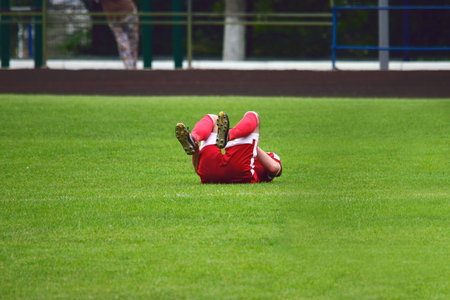 soccer player injured lying on the grassの写真素材