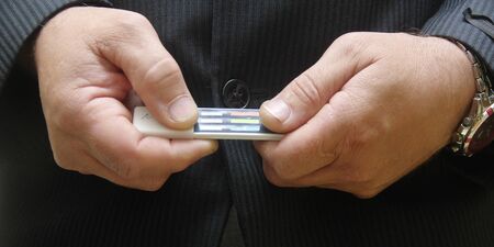 Multi panel drug test device on hand man .の写真素材