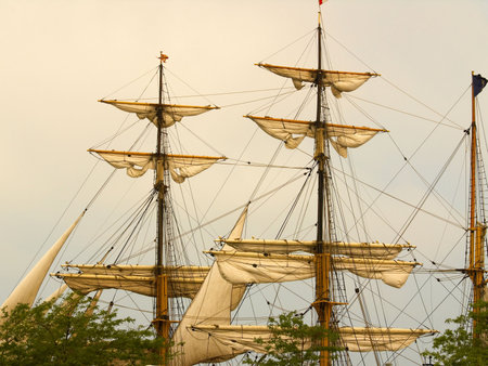 Sails of a tall ship (barque) in warm light
