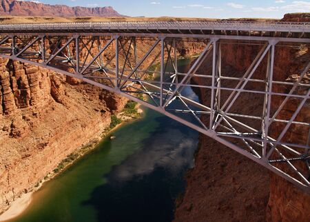 Navajo Bridge arching over the Colorado River at Marble Canyonの写真素材