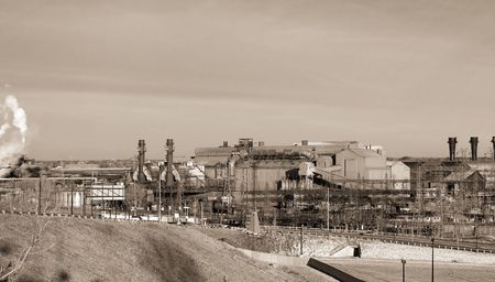 Sepia-toned view of old steel mill in an industrial valleyの写真素材