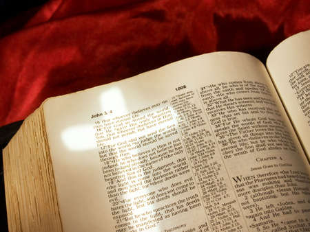 Cross shape of light stretching across John 3:16 in the Bibleの写真素材