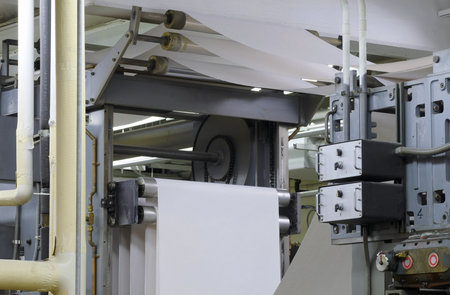 Paper threading its way through a printing press during a press run