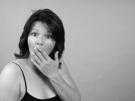 Beautiful woman displaying an expression of shockの写真素材