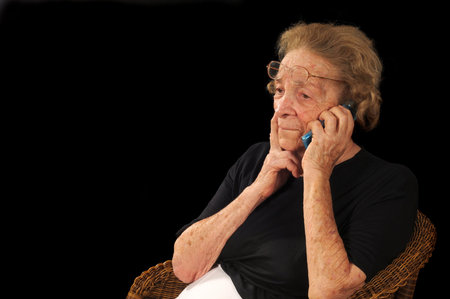 Grandmotherly woman talking on a cell phoneの写真素材