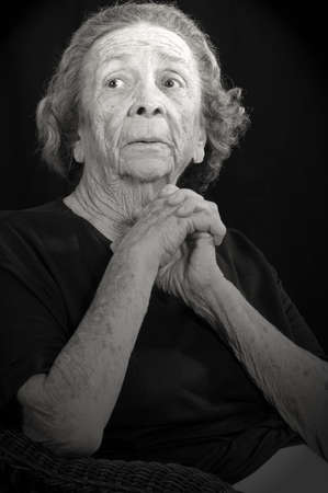 An elderly woman with worry in her eyes and demeanorの写真素材
