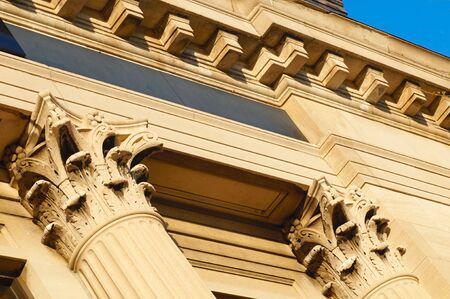 Angled detail of Corinthian style columns and cornice detail on a bank buildingの写真素材