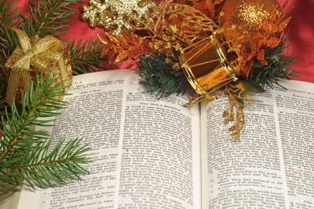 Bible open to the Christmas passage of Luke 2 with festive decorations
