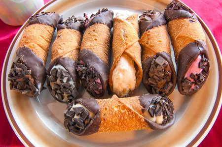 A variety of cannoli with fillings of different flavors and colorsの写真素材