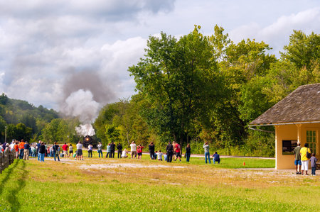 BRECKSVILLE, OH - SEPTEMBER 6, 2014: Passengers wait for a photo op as the steam train approaches on...