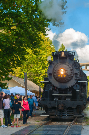 BRECKSVILLE, OH - SEPTEMBER 7, 2014: A steam locomotive on the Cuyahoga Valley Scenic Railroad waits as passengers board at the Brecksville station south of Clevleand.のeditorial素材