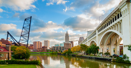 The Cuyahoga River bends past downtown Cleveland by the Veterans Memorial Bridge with old lift bridge at leftのeditorial素材