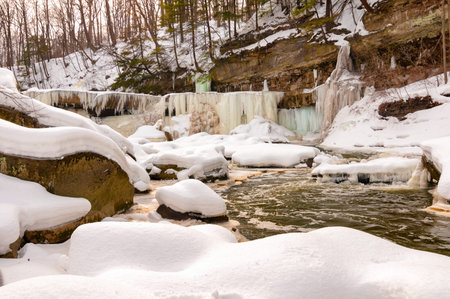 The iced-over Great Falls of Bedford Ohio seen from downstream at creekside