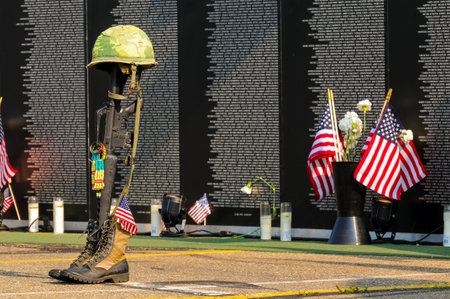 TWINSBURG, OH, USA - JULY 4, 2015: A fallen soldier tribute stands before panels of a replica...