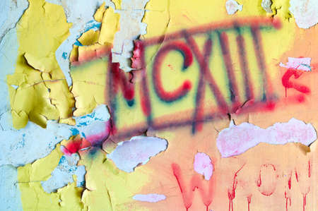 Peeling paint on an old wall that has been vandalizedの写真素材