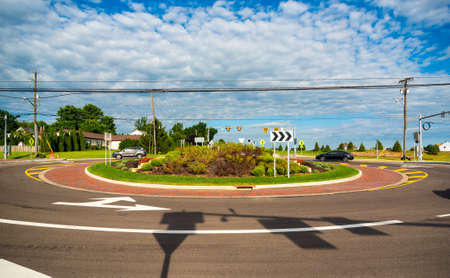 TWINSBURG, OH - JUNE 24, 2017: Vehicles navigate a newly constructed traffic roundabout in this northeast Ohio suburb.のeditorial素材