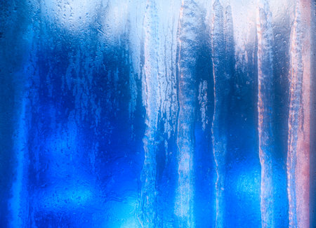 Frosted window in blue and pink with backlit ice drips