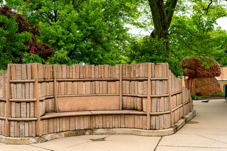 KENT, OH - MAY 21, 2018: The secluded âBrain Plazaâ on the KSU campus features stone benches embedded in carved shelves of books and a sculpture of a giant brain.のeditorial素材