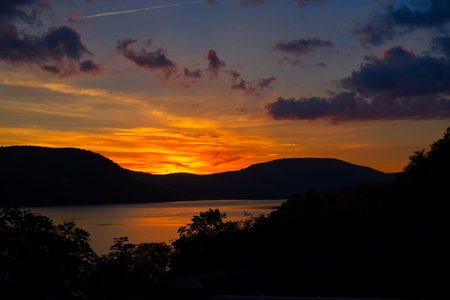 The setting sun casts a brilliant glow over the Hudson River at Peekskill New York