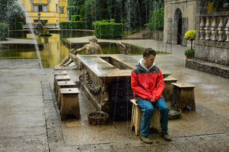 SALZBURG, AUSTRIA - MAY 28, 2019: A tour group volunteer sits on the archbishopâ€™s seat as the...