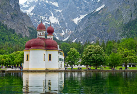 UPPER BAVARIA, GERMANY - MAY 27, 2019: The onion-domed church of Bartholomew (Kirche St. BartholomÃ¤) greets visitors at the intermediate stop for the excursion boat tours on this long mountain lake.のeditorial素材