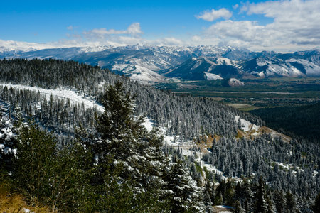 Vista overlooking the southern end of Jackson Hole Wyoming from near the top of Teton Pass Highway with a dusting of early autumn snowの写真素材