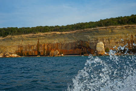 Painted Coves at Pictured Rocks National Lakeshore, near Munising, Michigan; cruise boat spray in foregroundの写真素材