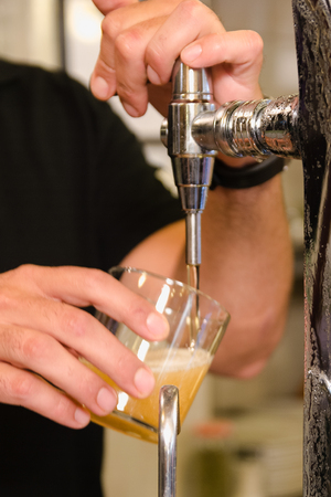 Waiter pouring beerの写真素材