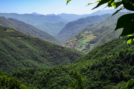 Village located in a beautiful location surrounded by mountains with a beautiful blue sky in the...